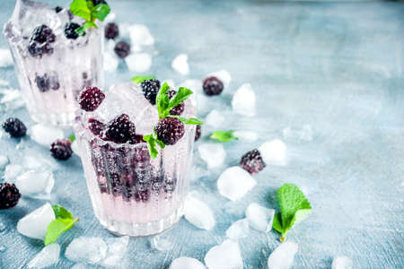 Homemade blackberry lemonade on light blue concrete background copy spaceの写真素材