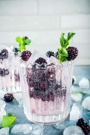 Homemade blackberry lemonade on light blue concrete background copy spaceの写真素材