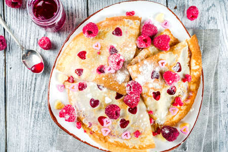 Idea for Valentine's Day surprise gift. Cute pancakes crepes with berry sauce and heart shaped...