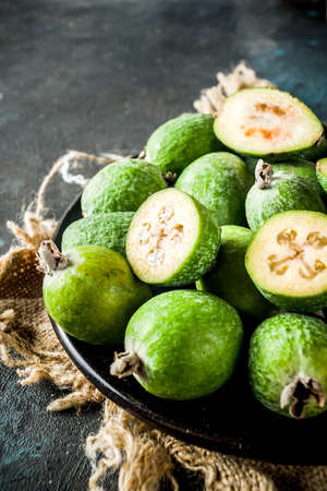 Tropical fruit, raw organic feijoa on a dark blue concrete background, copy spaceの写真素材