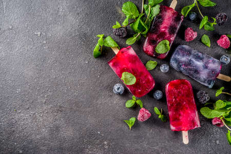 Simple and healthy summer dessert. Homemade berry ice cream  with mint. Mojito lollypops, frosen...