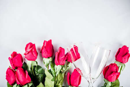 Valentine day concept, Red roses with two champagne glasses, copy space top viewの写真素材