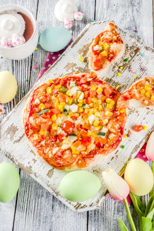 Funny easter food, ideas recipes for children Easter party, healthy  kids pizza with vegetables, top view copy spaceの写真素材