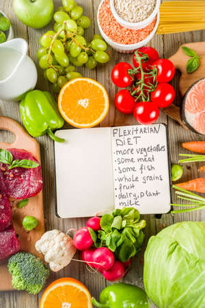 Flexitarian diet diet, with fresh vegetables, raw meat and fish, legumes, grains, fruit, wooden background, copy space top viewの写真素材