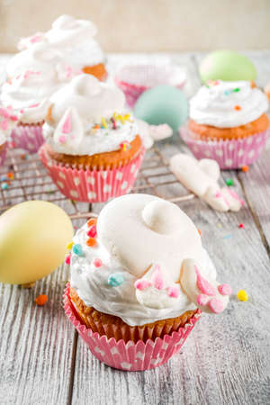 Easter kids party treat. Festive Easter food. Homemade cupcakes with cream and marshmallow cute...