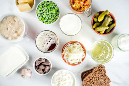 Super Healthy Probiotic Fermented Food Sources, drinks, ingredients, on white marble background copy...