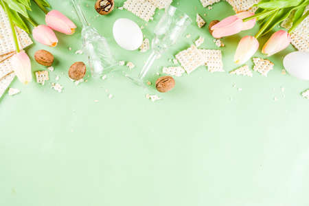 Pesah celebration concept. jewish Passover holiday background with matzo, eggs, spring flowers,...