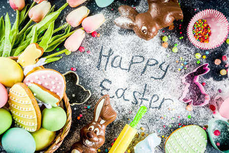 Easter greeting card background. Cooking gingerbread cookies ingredients, With colorful eggs. cookies and sugar sprinkles top view copy spaceの写真素材