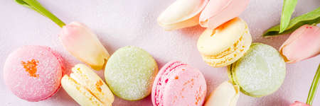 Classic colorful macarons. Six pink, yellow and green macaron cookies top view copy spaceの写真素材