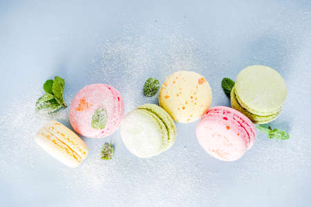 Classic colorful macarons. Six pink, yellow and green macaron cookies top view copy spaceの写真素材
