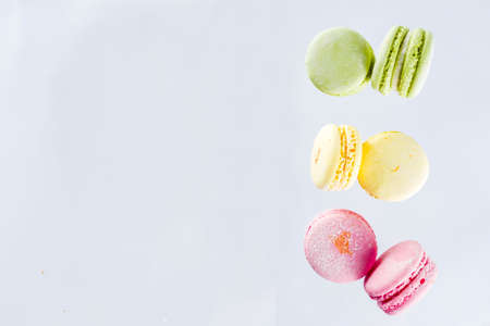Classic colorful macarons. Six pink, yellow and green macaron cookies top view copy spaceの写真素材