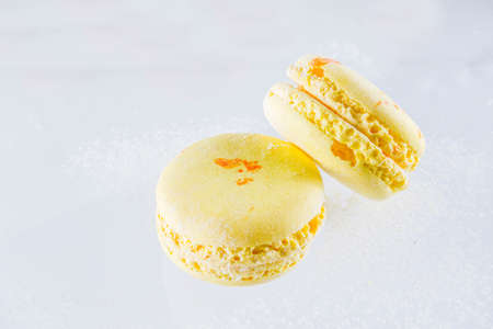 Classic colorful macarons. Six pink, yellow and green macaron cookies top view copy space