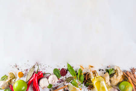 Various herbs and spices on white background top view copy space