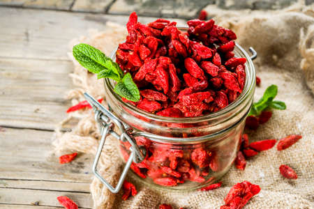 Dried goji berries in little jar, wooden background copy spaceの写真素材