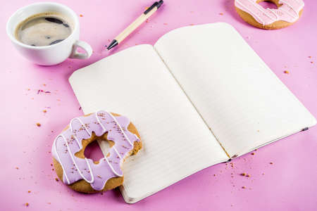 Rest and relaxation concept, coffee cup and biscuits donut with sugar coating, with a notepad for...
