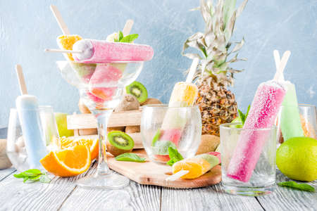 Colorful fruit ice cream e. Juicy gelato lollypops on sticks, with different fresh tropic fruits,...
