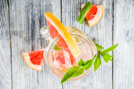 Summer refreshment drinks. Four types of citrus lemonade or mojito cocktail - orange, lime, lemon, pink grapefruit. Infused citrus water.の写真素材