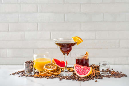 Negroni coffee cocktail with ingredients - coffee, orange, grapefruit, spices, liqueur, white marble background copy spaceの写真素材