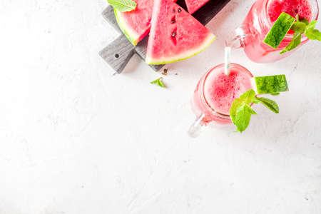 Cold summer drink. Homemade watermelon smoothie. White concrete or stone background copy spaceの写真素材