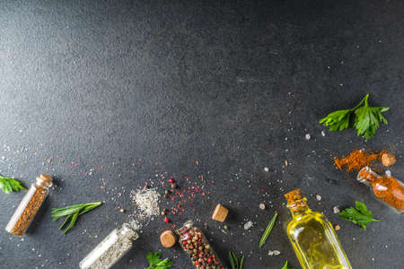 Cooking food background with herbs, olive oil and spices, black stone concrete background above copy spaceの写真素材