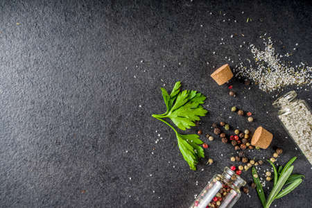 Cooking food background with herbs, olive oil and spices, black stone concrete background above copy spaceの写真素材