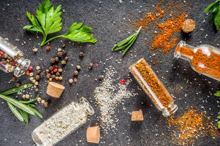 Cooking food background with herbs, olive oil and spices, black stone concrete background above copy spaceの写真素材