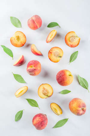 Fresh organic peaches, simple pattern, layout on white backgroundの写真素材