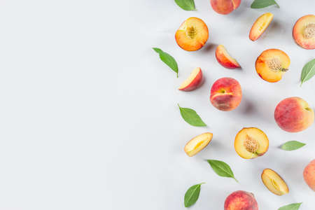 Fresh organic peaches, simple pattern, layout on white backgroundの写真素材
