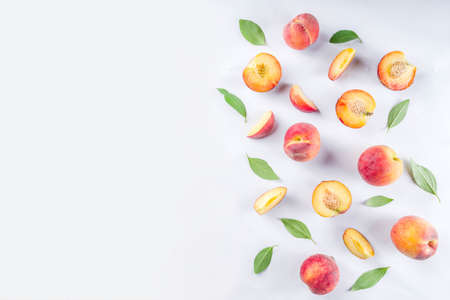 Fresh organic peaches, simple pattern, layout on white backgroundの写真素材
