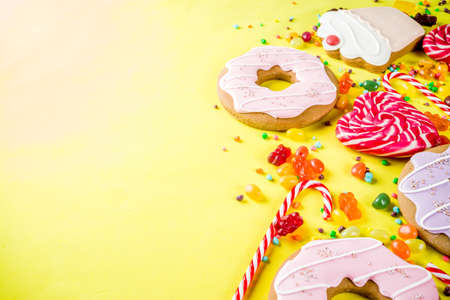 Sweets creative lay out, dessert concept with lollipops, jellies, candy, cookies donuts and...