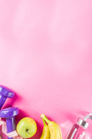 Fitness and healthy food concept. Dumbbells, fruits, water bottle, towel. Top view with copy spaceの写真素材