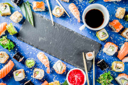 Assorted sushi set on stone or concrete background.  Japanese classic sushi, sushi nigiri. rolls, soy sauce, ginger, chopsticks. Top view. copy spaceの写真素材