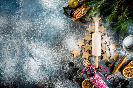 Merry Christmas background with traditional xmas gingerbread cookies, with decorations on dark blue concrete background copy spaceの写真素材
