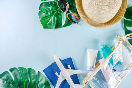 Travel and vacation flatlay concept. Summer bright colorful background with hat, sunglasses, plane, ...