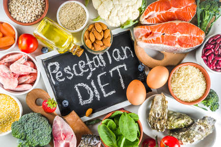 Pescetarian diet plan ingredients, healthy balanced grocery food, fresh fruit, berries, fish and shellfish clams, white marble background copy space の写真素材