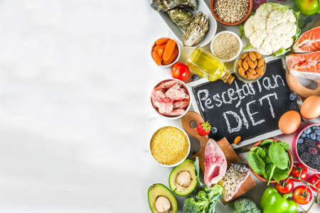 Pescetarian diet plan ingredients, healthy balanced grocery food, fresh fruit, berries, fish and shellfish clams, white marble background copy space の写真素材