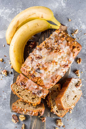 Homemade banana bread with walnuts, gray stone concrete background copy space, Vegan food.の写真素材