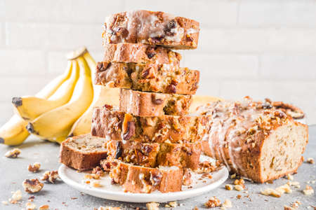 Homemade banana bread with walnuts, gray stone concrete background copy space, Vegan food.
