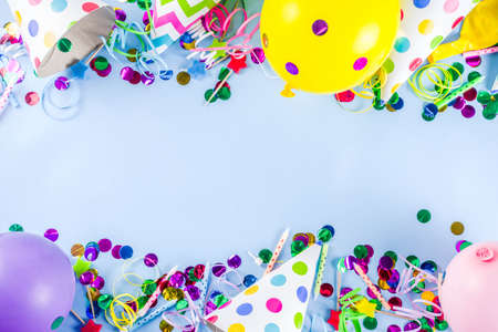 Birthday party decoration background with balloons, gift boxes, steamers and confetti, trendy light blue table copy space aboveの写真素材