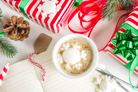 Preparation for Christmas background with gifts box, xmas decoration, coffee cappuccino cup and...