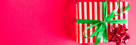 Christmas gift boxes simple pattern background. Festive boxes with Christmas presents, decorated with bright bows with ribbons. Flatlay, above copy spaceの写真素材