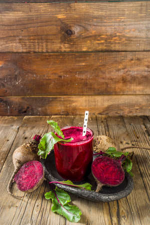 Vegan healthy diet drink. Beetroot detox juice or smoothie, on rustic wooden table with copy spaceの写真素材