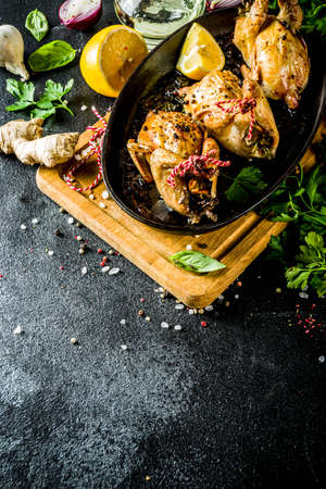 Delicious fried roasted quails with herbs, spices and greens. Grilled quails carcasses in a baking dish. Holiday Christmas and Thanksgiving meal concept.の写真素材