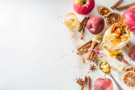Autumn healthy breakfast idea. Overnight oatmeal in a mason jar with spiced honey apple, spices and candied orange.の写真素材
