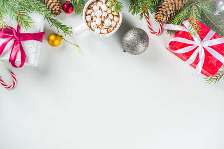 Christmas greeting card background with fir tree and decoration, white table background flat lay top...