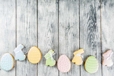Easter greeting card  with pastel colored eggs and homemade cookies shaped in eggs and bunnies...