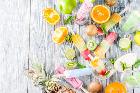 Colorful fruit ice cream with different fresh tropic fruits, woodenの写真素材