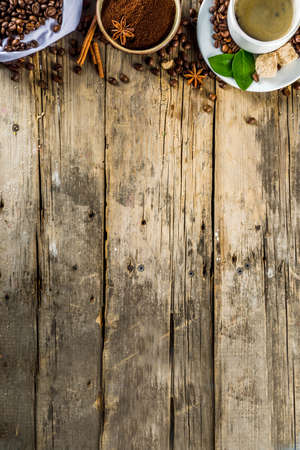 Cup of espresso with coffee beans. ground coffee and leaves on rustic background の写真素材