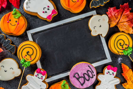 Halloween background with Funny Gingerbread Cookies - pumpkins mummy, zombies, ghosts, spiderweb. Top view with copy space.の写真素材