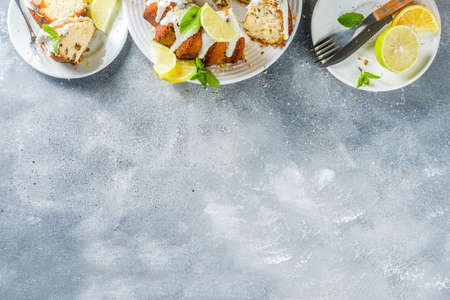 Homemade lemon bundt cake with sugar icing, fresh lemons and mint leaves, copy spaceの写真素材